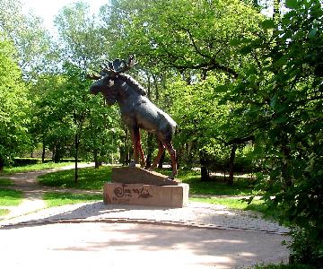 Фото скульптуры лося в парке.